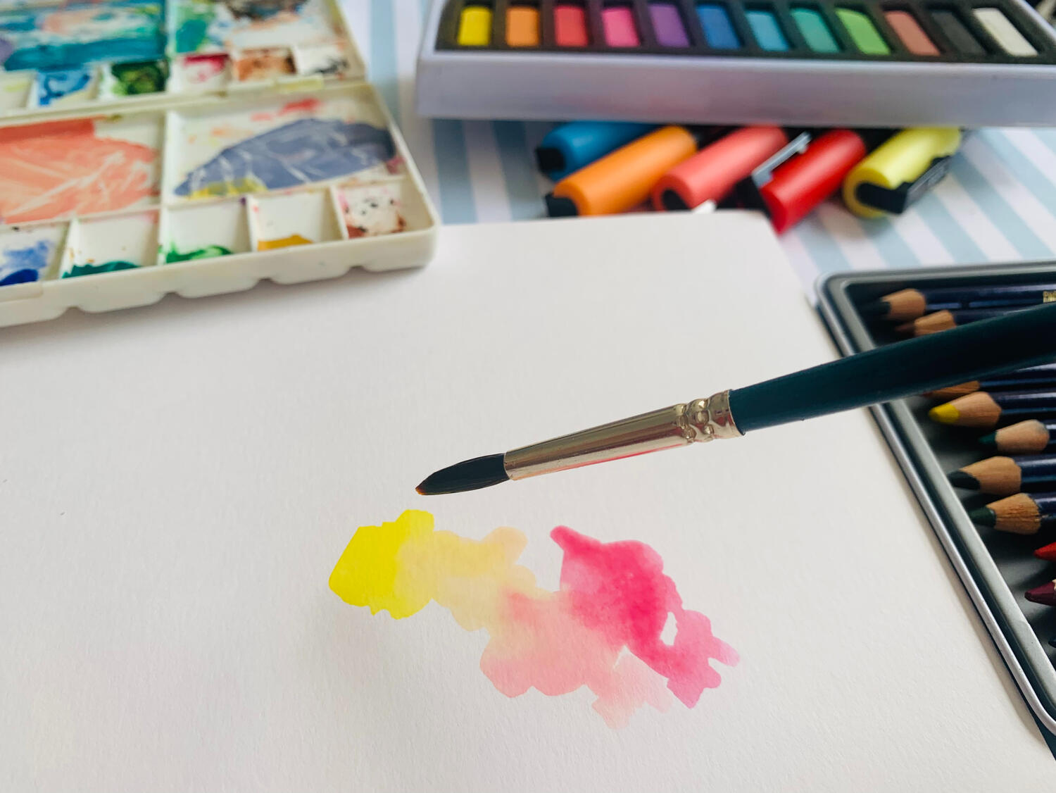 Diwa art therapy - brush applying paint to paper.